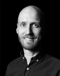 Close-up of a smiling, bearded man.