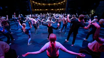 A large group of people dancing on a stage.