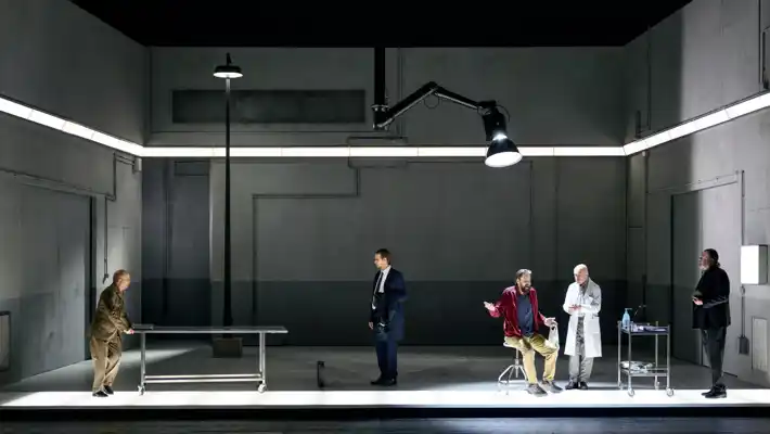 A group of people standing around a room.