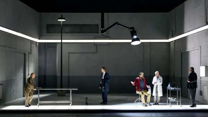 A group of people standing around a room.