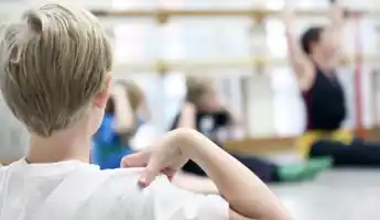 A young person doing movements during a workshop.