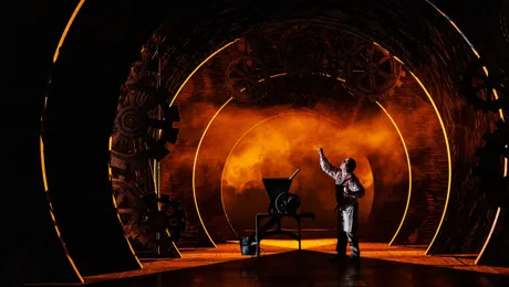 A man stands next to a machine on a stage.