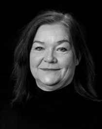 Close-up of a woman with medium-length, dark hair.