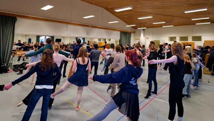 A group of people dancing in a large room.