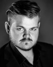 A close-up of a young man, taken obliquely from above.