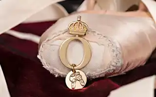 Pink pointe shoe with jewelry on the pointe.