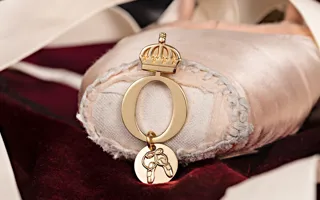 Pink pointe shoe with jewelry on the pointe.