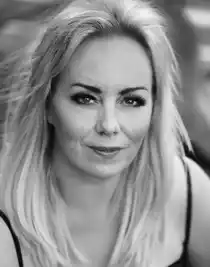 A close-up of a blonde woman, taken obliquely from above.