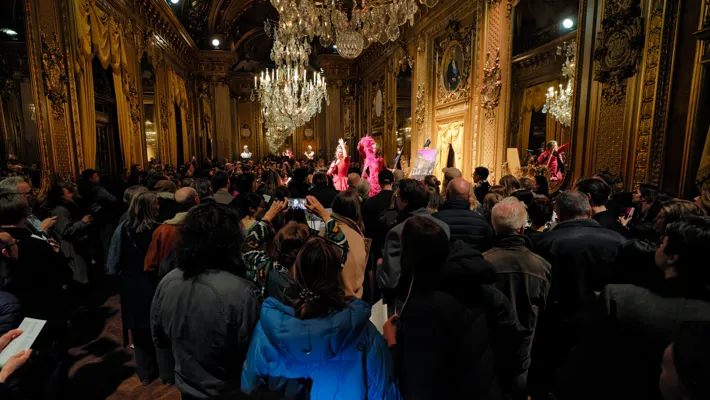 A large group of people standing in a room.