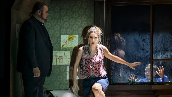 A man and a woman standing in a room.