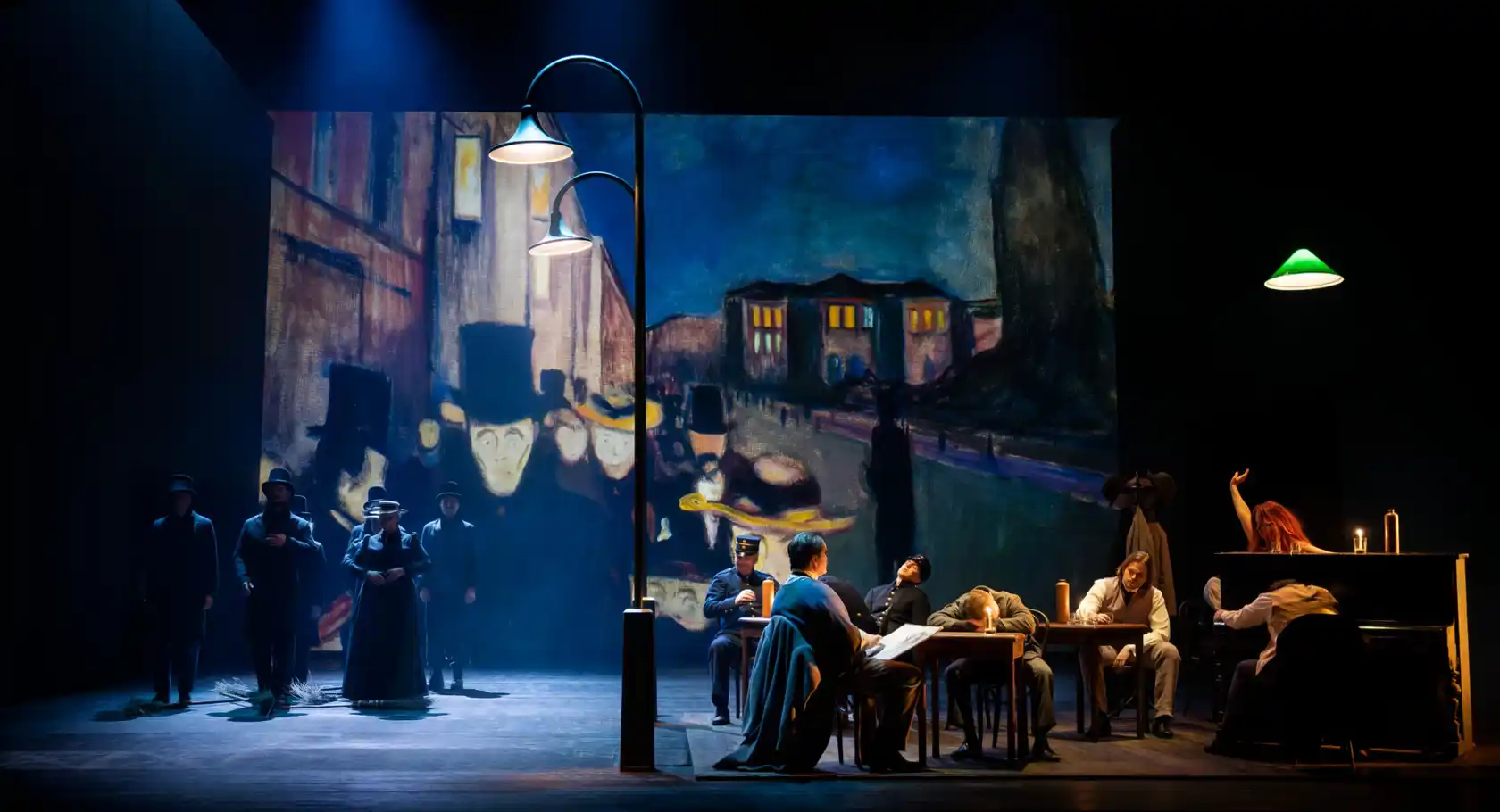 A group of people sitting around a table on a stage.