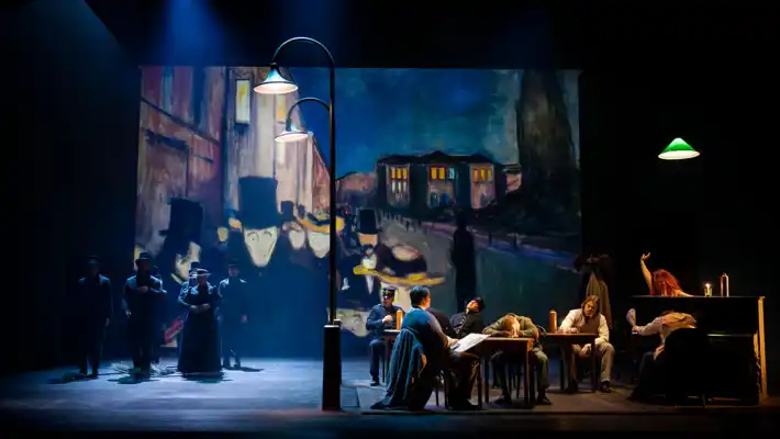 A group of people sitting around a table on a stage.