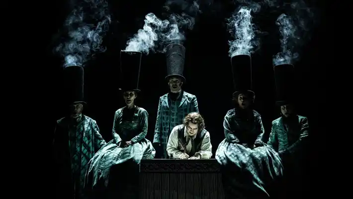 A group of people standing around a table, smoke rising from their hats.