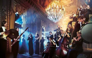Several musicians with instruments in a grand room with a large chandelier, light shining in from the left.