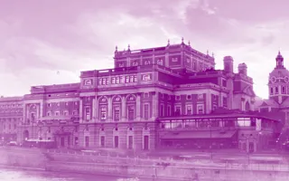 A large house by a stream, a church in the background, all covered in a purple color.
