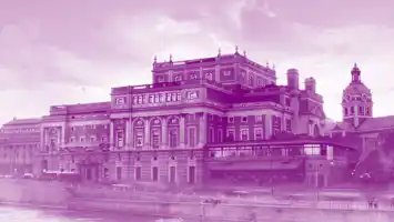 A large house by a stream, a church in the background, all covered in a purple color.