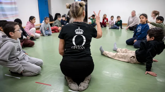 Young Opera Workshop Opera A group of children sitting on the floor in a circle.